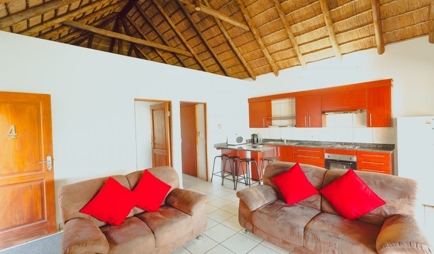 Open-plan lounge area with fully equipped self catering kitchen.