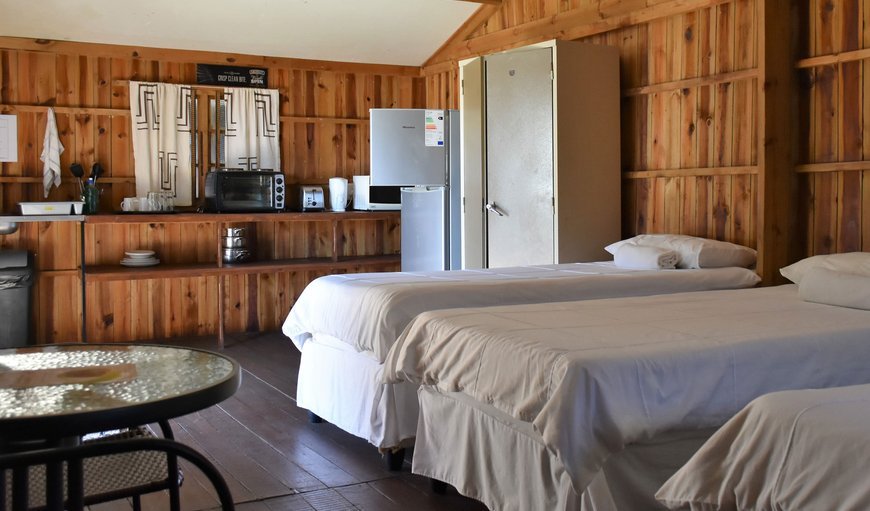 Pleasant Waters Standard Chalet beds and kitchenette