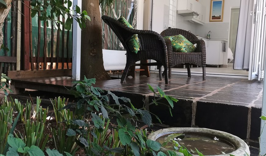 Patio leading on to a lush green private garden.